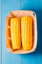 ÃÂ¡orn. Fresh yellow corn on wooden blue table closeup. Top view. Yellow corn in small basket on blue wooden background Royalty Free Stock Photo