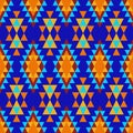 Colorful Indian ornament of yellow, orange and blue, diamonds and triangles on a dark blue background. Royalty Free Stock Photo