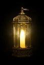 Ornamental Arabic lantern with burning candle glowing