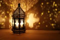 Ornamental Arabic lantern with burning candle glowing at night and glittering golden bokeh lights. Festive greeting card Royalty Free Stock Photo