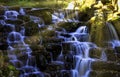 Ornamental Cascade waterfall with visible sun rays - Virginia Water, Surrey, United Kingdom