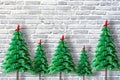 Ornamental Christmas tree from origami paper on grey bricks wall, holiday greeting background