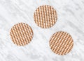 Ornamental cork coasters on marble background