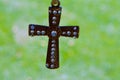 An ornamental cross hanging on a rope. Royalty Free Stock Photo