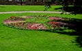 Ornamental flower bed in front of the castle on the ground floor. Planting annuals has the shape of a circle or strips bordered by Royalty Free Stock Photo