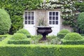 Ornamental flower pot in topiary hedge garden, elegant landscaped . Royalty Free Stock Photo