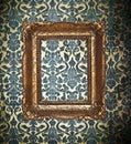 Ornamental gold frame on a damask wallpaper Royalty Free Stock Photo