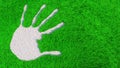 Ornamental gravel handprint on grass background