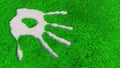 Ornamental gravel handprint on grass background