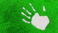 Ornamental gravel handprint on grass background