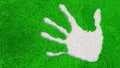 Ornamental gravel handprint on grass background