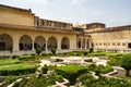 Ornamental green gardens in Amber Fort, Jaipur, India with tourists visiting this landmark