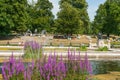 Ornamental Italian Gardens in Kensington Gardens with bronze statue of Jenner and people sunbathing in deck-chairs on a sunny