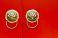 Ornamental knockers on red door