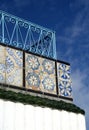 Ornamental railing on roof top terrace and green roof tiles in Tunisia Royalty Free Stock Photo