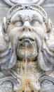 ornamental sculpture of a human head gushing liquid from the mouth