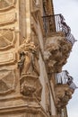 Italy, Sicily, Scicli Ragusa province, ornamental statues of the Baroque Beneventano Palace. In a corner the figure of a saint