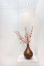 Ornamental vase with artificial stick branches and leaves in it Royalty Free Stock Photo