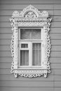 Ornamental window with carved frame of traditional russian rural wooden house Royalty Free Stock Photo