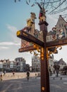 Ornamental wooden signpost with the directions to Mechelen`s main tourist landmarks, Belgium