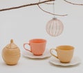 an ornamented toy ball, colorful cups with saucers, and a sugar-bowl Royalty Free Stock Photo