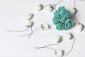 Ornaments for celebrations. A bouquet of artificial flowers. Rose beige and emerald colors. On a white background.