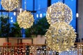 Ornaments and lights in the shopping center. Christmas decorations on the holiday. Colorful balls garland glowing lamps. Royalty Free Stock Photo