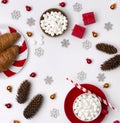 Ornaments, pine cones, cup of hot chocolate with marshmallow, croissant and red gift boxes on a white background Royalty Free Stock Photo