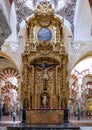 Ornate altarpiece with Crucifix and painting Assumption in the Mosque-Cathedral of Cordoba in Spain.