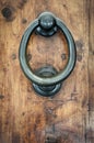 Ornate Antique Door Knocker on Weathered Wood Royalty Free Stock Photo