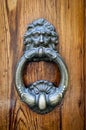 Ornate Antique Door Knocker on Weathered Wood Royalty Free Stock Photo