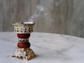 Arabian Bakhoor incense burner emitting white smoke. With copy space Royalty Free Stock Photo