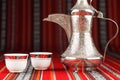 Ornate arabian tea cups and a dallah tea pot Royalty Free Stock Photo