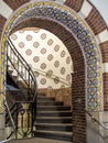 Ornate arch opening to a spiral stairwell