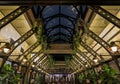 Ornate art deco interior with glass ceiling sky light decorated with metal beams, flowers and vintage light fixtures