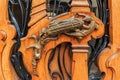 Ornate art nouveau wooden door detail with organic motif and handle shaped like a lizard eating an ear of corn in Paris, France Royalty Free Stock Photo