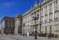 Ornate baroque architecture of the Royal Palace viewed from Plaza de Oriente and police car outside in Madrid, Spain