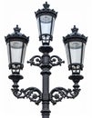Ornate Black Cast Iron Lamp Post with Three Lights on White Background Royalty Free Stock Photo