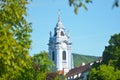 An ornate blue steeple in a village.