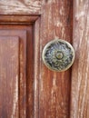 Ornate brass door handle on brown wooden door, Batumi, Georgia