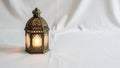 Ornate brass lantern with intricate geometric patterns casting a warm glow Royalty Free Stock Photo