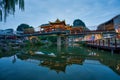 Ornate bridge in an oriental city reflected on the water's surface.