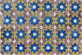 Ornate brightly colored Portugese tile texture in blue, purple, olive and yellow