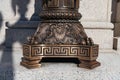 Ornate bronze architectural base with classical decorative patterns and detailed relief design Royalty Free Stock Photo