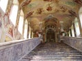 Ornate building with intricate architectural details, featuring a staircase leading up to a church