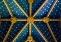 Ornate carved vaulted interior ceiling of cathedral decorated in blue and gold Royalty Free Stock Photo