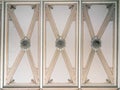 Ornate ceiling panel with symmetrical neoclassical design, featuring intricate patterns, decorative moldings, and beige Royalty Free Stock Photo