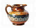 Ornate Ceramic Pitcher with Brown Glaze and Blue Detailing on White Background Royalty Free Stock Photo