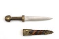 Ornate ceremonial dagger next to a jeweled scabbard Royalty Free Stock Photo