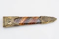 Ornate ceremonial dagger next to a jeweled scabbard